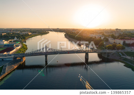 Golden sunset over Tver Russia shows the Old Volga Bridge carrying cars across the wide river Golden sunset over Tver Russia shows the Old Volga Bridge carrying cars across the wide river 139865357
