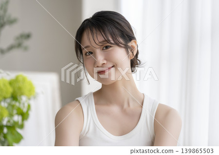 A young woman smiling at camera A young woman smiling at camera 139865503