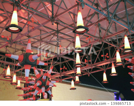 Nighttime illuminated cone lights under metal canopy Nighttime illuminated cone lights under metal canopy 139865713