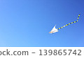 White Kite Flying High In Blue Sky 139865742