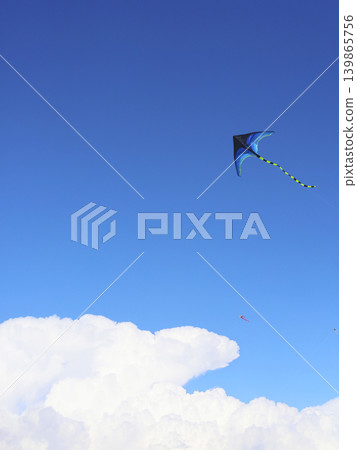 Kite Flying Over Bright Blue Summer Sky Kite Flying Over Bright Blue Summer Sky 139865756