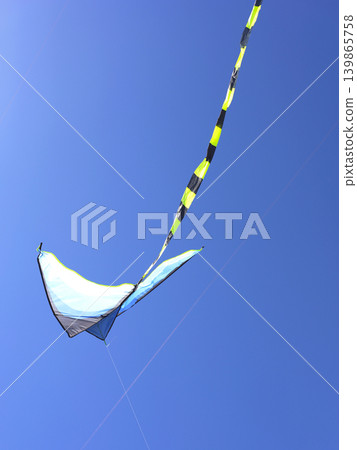Bright Kite Soaring High Against Blue Sky 139865758