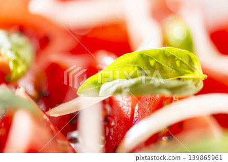 Fresh ingredients, with a refreshing basil leaf garnish on top of a red tomato. Fresh ingredients, with a refreshing basil leaf garnish on top of a red tomato. 139865961