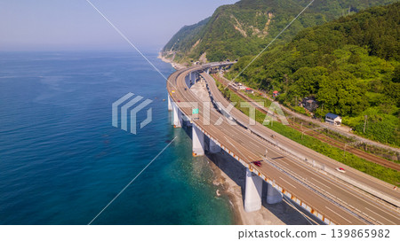 The blue Sea of Japan and the Hokuriku Expressway running along the coastline (Oyashirazu, copy space) The blue Sea of Japan and the Hokuriku Expressway running along the coastline (Oyashirazu, copy space) 139865982