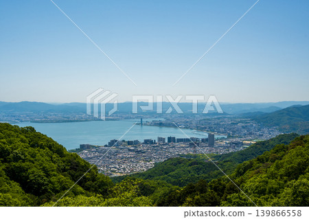 A panoramic view of Lake Biwa and the city of Otsu in early summer, seen from Mount Hiei. A panoramic view of Lake Biwa and the city of Otsu in early summer, seen from Mount Hiei. 139866558