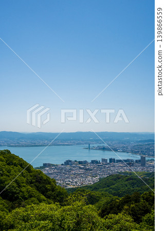 Lake Biwa as seen from Mount Hiei, with its vast blue sky and lush greenery (vertical orientation, copy space) Lake Biwa as seen from Mount Hiei, with its vast blue sky and lush greenery (vertical orientation, copy space) 139866559
