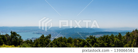A panoramic view of Lake Biwa and the city of Otsu bathed in the light of sunset. 139866561