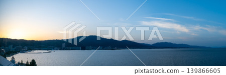 A panoramic view of Lake Biwa and the city of Otsu bathed in the light of sunset. A panoramic view of Lake Biwa and the city of Otsu bathed in the light of sunset. 139866605