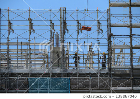 High-rise construction site and workers High-rise construction site and workers 139867040