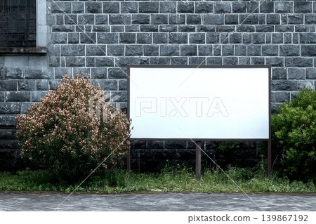 Wide format billboard in front of a stone wall. Wide format billboard in front of a stone wall. 139867192