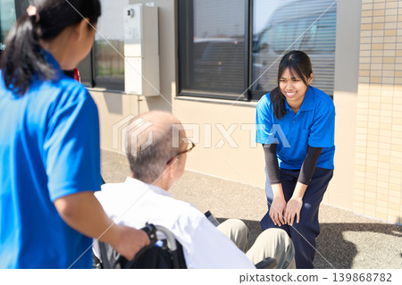Foreign caregivers welcoming senior residents at nursing homes 139868782