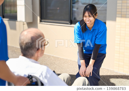 Foreign caregivers welcoming senior residents at nursing homes Foreign caregivers welcoming senior residents at nursing homes 139868783