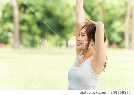 A female yoga instructor doing yoga, yoga class, pilates in the park or forest A female yoga instructor doing yoga, yoga class, pilates in the park or forest 139869553