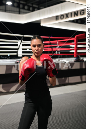 Female Boxer in Red Gloves Standing by Ring 139869654
