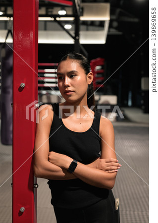Vertical Shot of Female Boxer Looking Away with Arms Crossed Vertical Shot of Female Boxer Looking Away with Arms Crossed 139869658