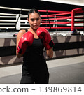 Medium Shot of Female Boxer in Fighting Stance 139869814