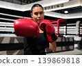 Horizontal Shot of Female Boxer Punching Towards Camera 139869818
