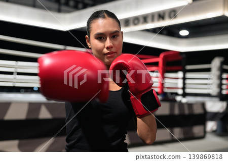Horizontal Shot of Female Boxer Punching Towards Camera Horizontal Shot of Female Boxer Punching Towards Camera 139869818