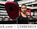 Horizontal Shot of Female Boxing Coach Holding Focus Mitt 139869819