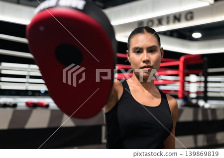 Horizontal Shot of Female Boxing Coach Holding Focus Mitt 139869819