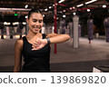 Smiling Female Athlete Checking Smartwatch in Gym 139869820