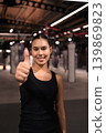 Smiling Female Athlete Giving Thumbs Up in Vertical Shot 139869823
