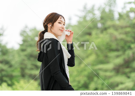 Woman running, walking, jogging, exercising (diet, sports) with earphones in the park Woman running, walking, jogging, exercising (diet, sports) with earphones in the park 139869841
