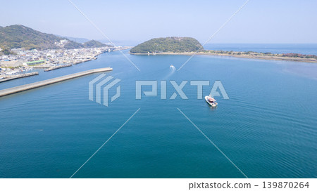 A ship sailing through the strait separating Yura Port on Awaji Island and Narugashima Island (drone aerial photography) 139870264