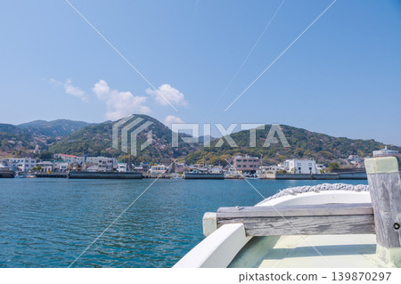 A view of Yura Port and Awaji Island in spring, seen from a ferry. A view of Yura Port and Awaji Island in spring, seen from a ferry. 139870297