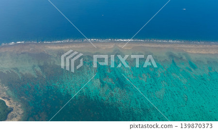 [Yonaguni Island] Yonaguni Island and the coral reef sea as seen from the air. 139870373