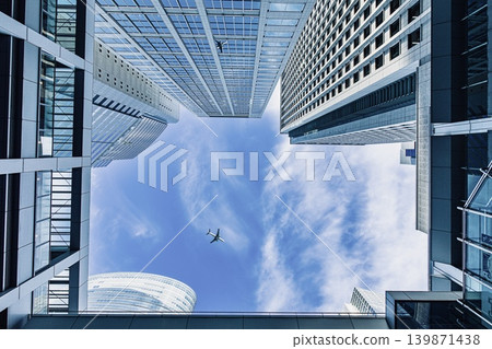 A cluster of buildings in Shinagawa, Tokyo, and an aircraft flying overhead. A cluster of buildings in Shinagawa, Tokyo, and an aircraft flying overhead. 139871438