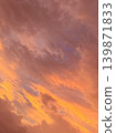 A dramatic sunset sky burning intensely in golden hues. 139871833