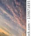The twilight clouds, tinged with a pale pink, and the blue sky. 139871835