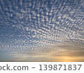 Beautiful cirrocumulus clouds spread across the entire twilight sky. 139871837