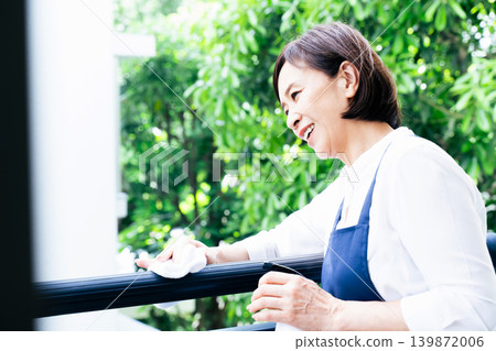 A woman cleaning the balcony A woman cleaning the balcony 139872006
