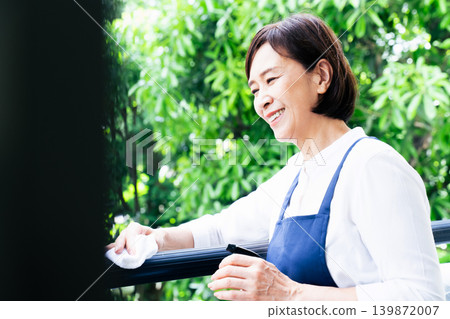 A woman cleaning the balcony A woman cleaning the balcony 139872007