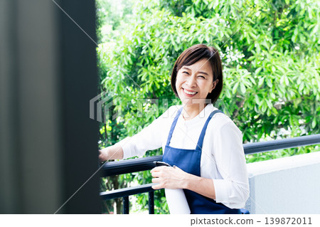 A woman cleaning the balcony A woman cleaning the balcony 139872011