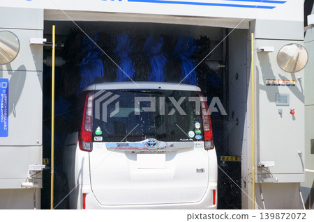 Cars being washed in a gas station car wash Cars being washed in a gas station car wash 139872072