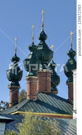 Orthodox church with green onion domes against clear blue sky Orthodox church with green onion domes against clear blue sky 139872565