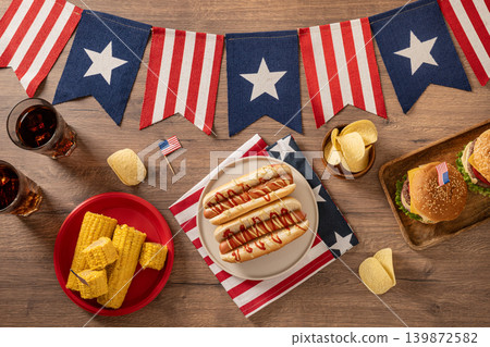American Independence Day barbecue table with burgers hot dogs and patriotic party food American Independence Day barbecue table with burgers hot dogs and patriotic party food 139872582