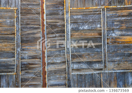 Weathered Wooden Surface with Rusty Metal Straps Weathered Wooden Surface with Rusty Metal Straps 139873569