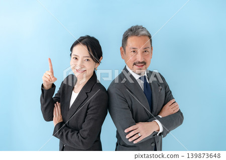 Business, man and woman, arms crossed, pointing. 139873648