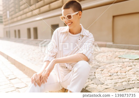 Beautiful woman in stylish clothes and short hair poses. Minimalism, urban style clothes. 139873735