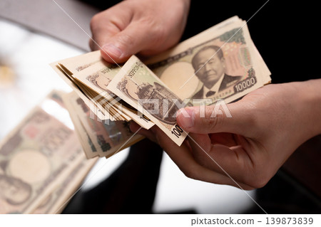 A man counting money A man counting money 139873839