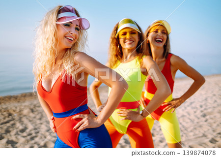 Young dancers in colorful swimsuits are dancing in morning. ?oncept of sports, fitness Active sport. Young dancers in colorful swimsuits are dancing in morning. ?oncept of sports, fitness Active sport. 139874078