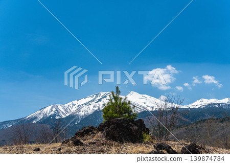 The scenery of Norikura Plateau in early summer and Mount Norikura with its remaining snow. The scenery of Norikura Plateau in early summer and Mount Norikura with its remaining snow. 139874784