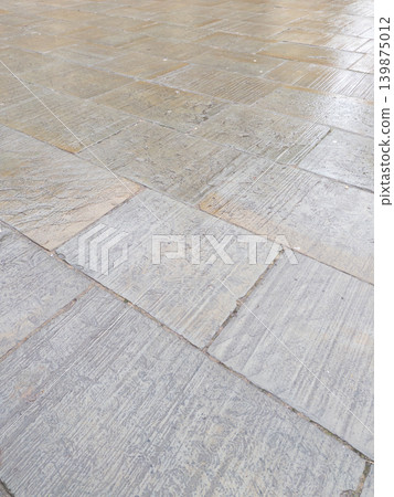 shiny wet surface of sidewalk paving stone shiny wet surface of sidewalk paving stone 139875012