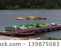 Pedal boats docked on a lake pier 139875083
