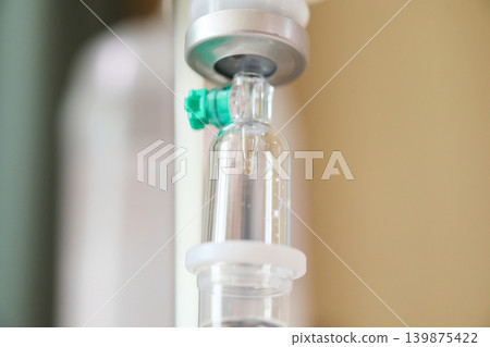 Close up medical intravenous IV drip in hospital background Close up medical intravenous IV drip in hospital background 139875422