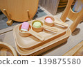 Cute sweets arranged on a wooden plate and wooden spoon. 139875580